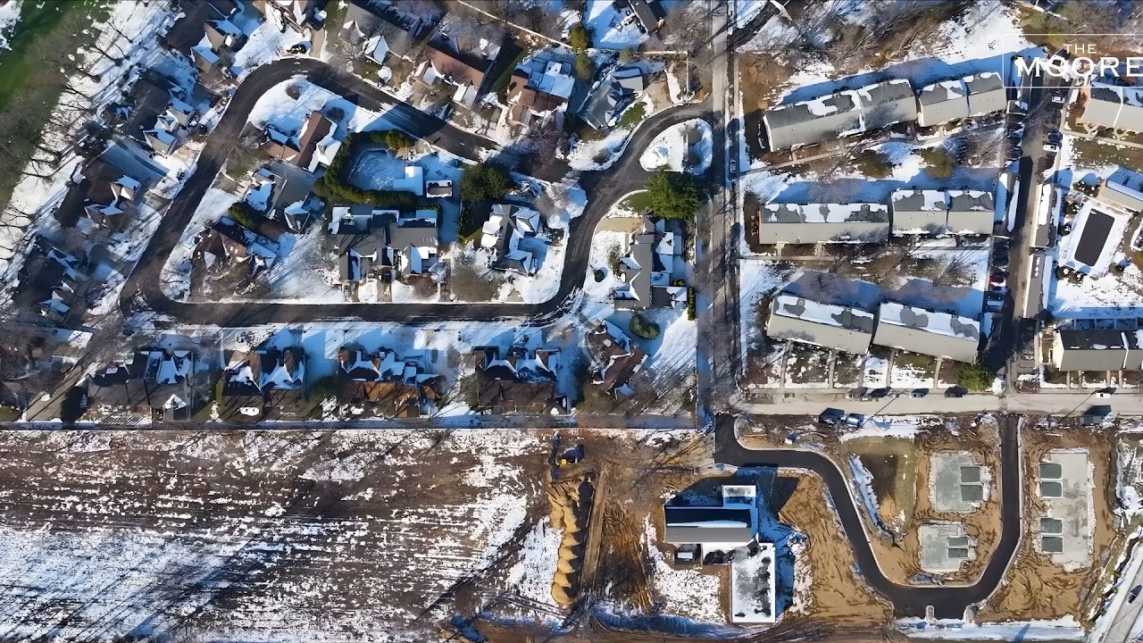 drone shot of New Construction in Long Beach Indiana showing neighborhood roads and new home foundations poured